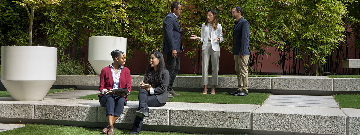 Three people in meeting outdoors